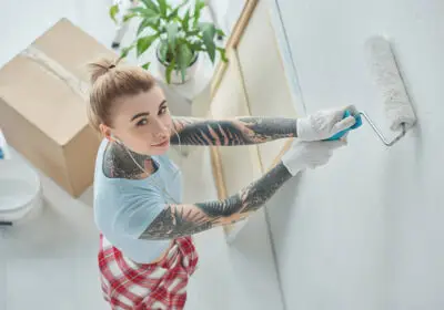 12-stock-photo-high-angle-view-young-tattooed-woman-earphones-painting-wall-new