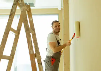 20-stock-photo-cheerful-painter-working-wall-using-paint-roller-apply-new-color