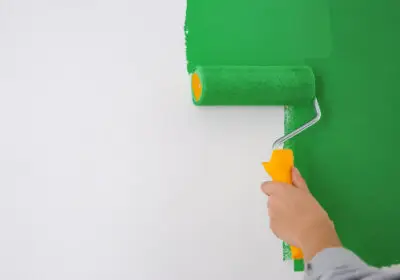 6-stock-photo-woman-painting-white-wall-green-dye-closeup-interior-renovation